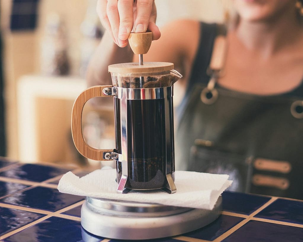 How to Make Cold Brew with French Press: Quick and Easy 4 Photo of Woman Using French Press