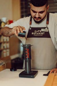 Aeropress vs French Press: Which Brews the Best Cup? 15 Barista Making Coffee at Cafe
